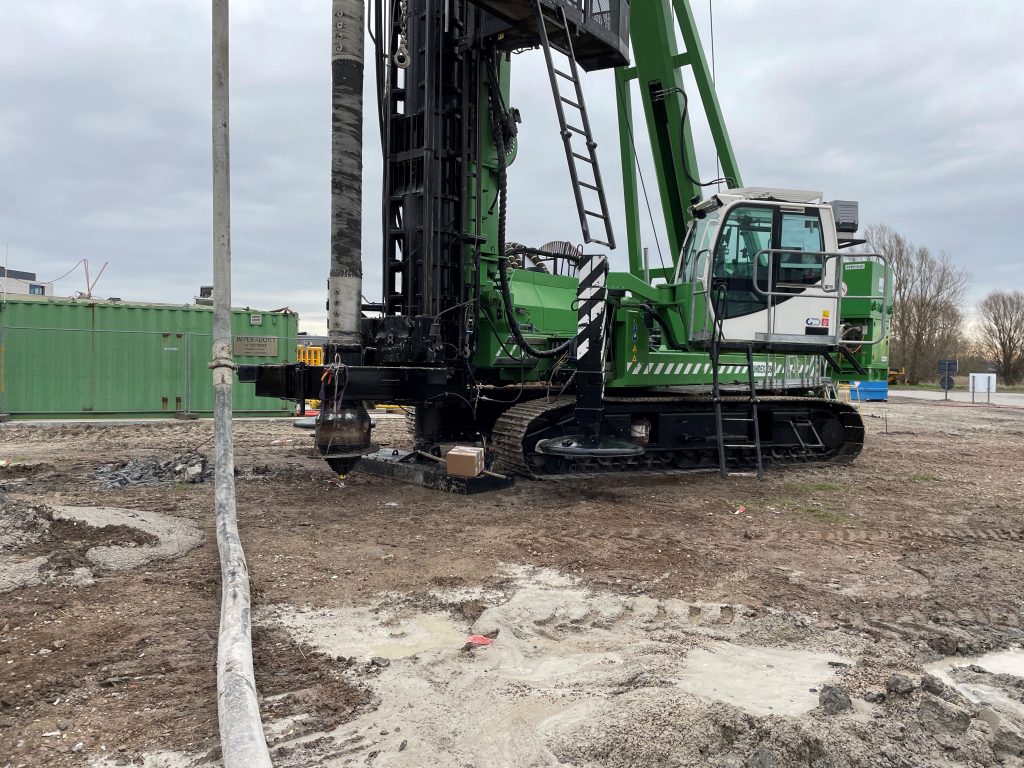 Groothoekbeeld van een Fundex F3500 boortelling met een Olivier DPA boorkop d61cm op een werf, klaar om te boren.